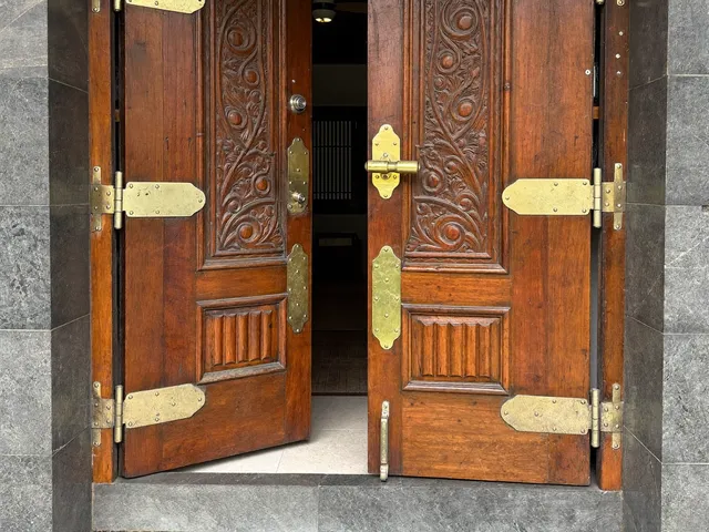 Carved Balinese teak door with new brass hinges