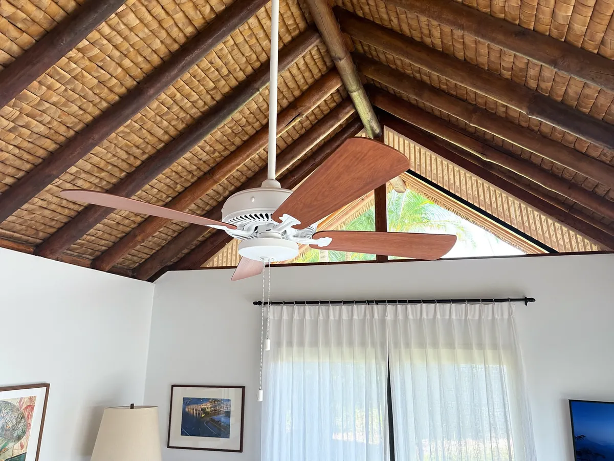 New ceiling fan installed on a vaulted bamboo ceiling of a Bali villa